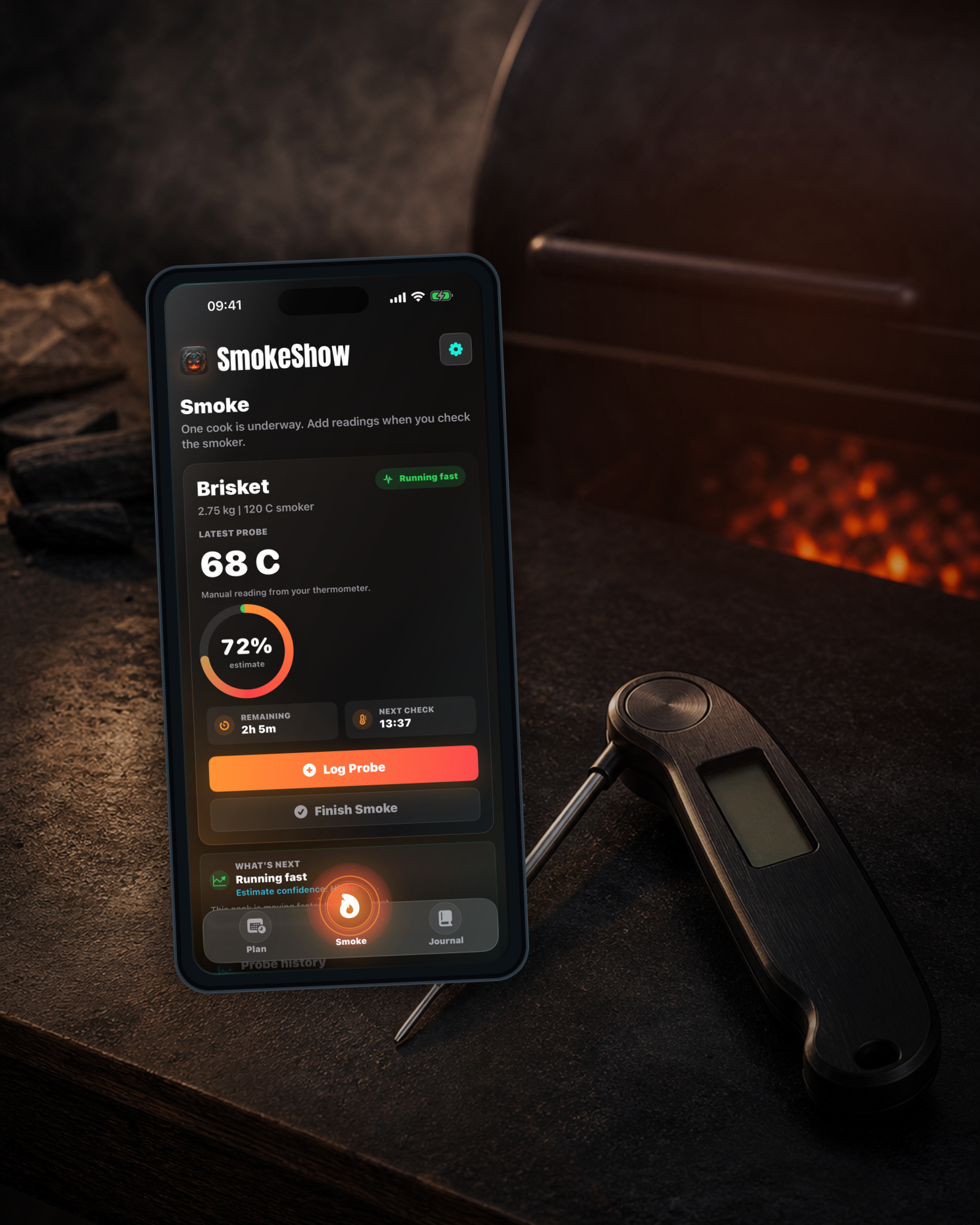 SmokeShow active Smoke screen beside a manual digital instant-read thermometer and grill glow